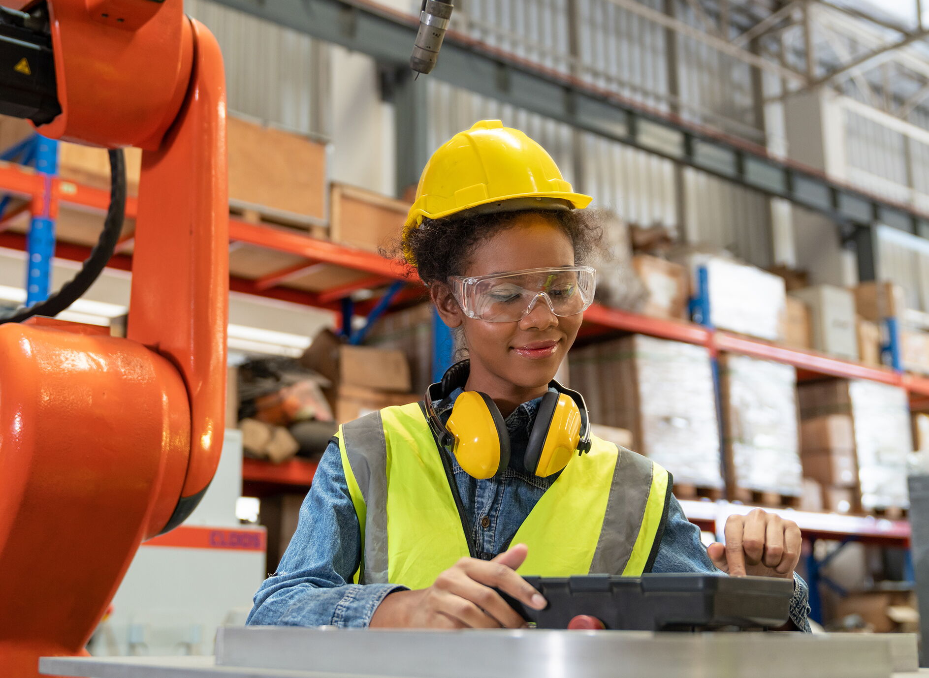 African American Female Worker in a Yellow Hardhat and Protective Goggles
